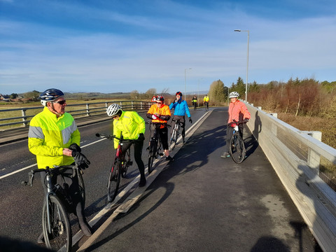 Cyclists stopped on overpass
