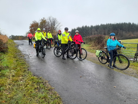 Several cyclists posing on a minor road