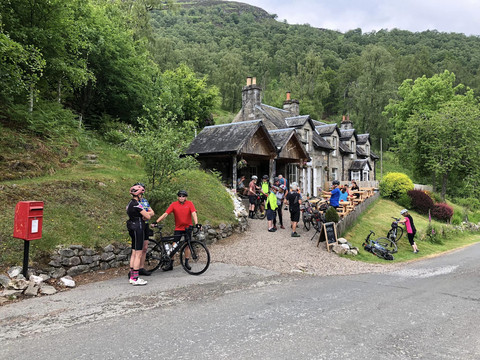 Cyclists outside rural cottages